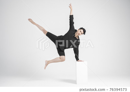 contemporary asian male dancer making move in white background contemporary asian male dancer making move in white background 76394573