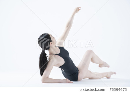 contemporary Asian female dancer making move in white background contemporary Asian female dancer making move in white background 76394673