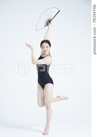 contemporary Asian female dancer making move in white background contemporary Asian female dancer making move in white background 76394706
