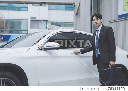 Asian male in suit with the car, business concept Asian male in suit with the car, business concept 76395153