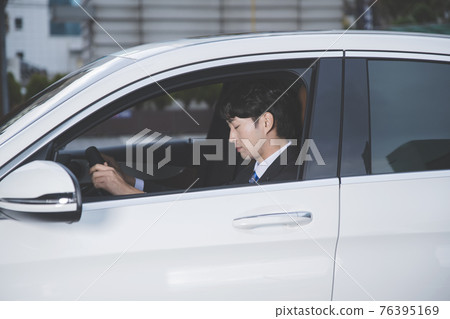 Asian male in suit in the car, drowsy driving concept 76395169