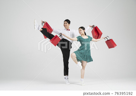 sale promotion concept, contemporary couple dancers with shopping bags sale promotion concept, contemporary couple dancers with shopping bags 76395192