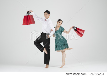 sale promotion concept, contemporary couple dancers with shopping bags sale promotion concept, contemporary couple dancers with shopping bags 76395231