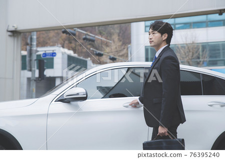 Asian male in suit with the car, business concept Asian male in suit with the car, business concept 76395240