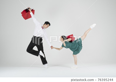 sale promotion concept, contemporary couple dancers with shopping bags 76395244
