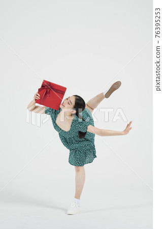 sale promotion concept, contemporary female dancer with shopping gift box 76395253