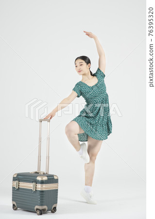 Asian female contemporary dancer with travel bag Asian female contemporary dancer with travel bag 76395320