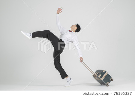 Asian male contemporary dancer with travel bag Asian male contemporary dancer with travel bag 76395327