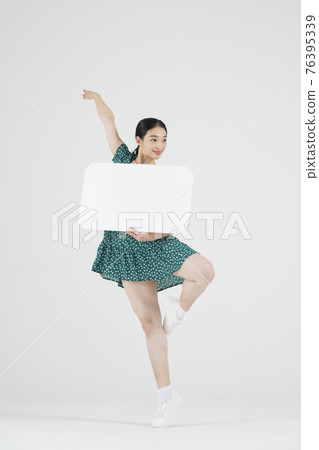 female Asian contemporary dancer holding speech bubble copyspace female Asian contemporary dancer holding speech bubble copyspace 76395339