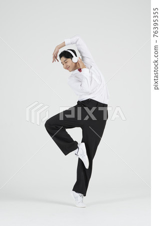 Asian male contemporary dancer making move with headset Asian male contemporary dancer making move with headset 76395355