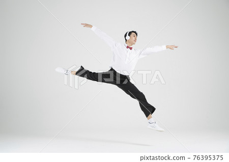 Asian male contemporary dancer making move with headset Asian male contemporary dancer making move with headset 76395375