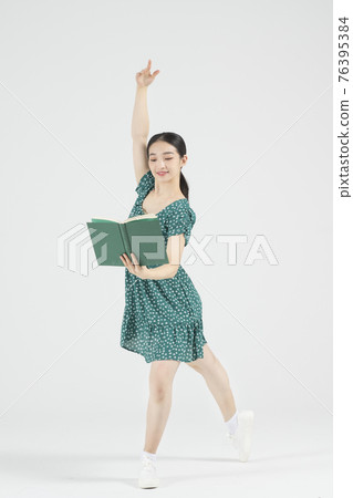 Asian female contemporary dancer holding book Asian female contemporary dancer holding book 76395384