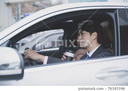 Asian male in suit with coffee in the car, business concept Asian male in suit with coffee in the car, business concept 76395396