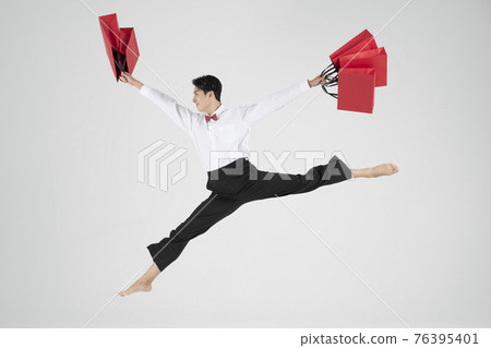 sale promotion concept, contemporary male dancer with shopping bags sale promotion concept, contemporary male dancer with shopping bags 76395401
