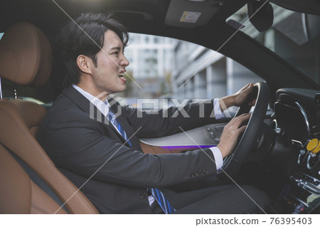 angry Asian male in suit in the car angry Asian male in suit in the car 76395403