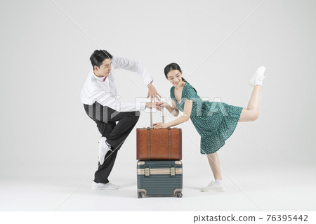 Asian couple contemporary dancers with travel bag Asian couple contemporary dancers with travel bag 76395442