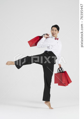 sale promotion concept, contemporary male dancer with shopping bags sale promotion concept, contemporary male dancer with shopping bags 76395447
