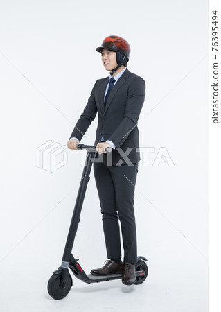 man riding electric scooter to work, white background 76395494
