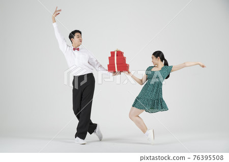 sale promotion concept, contemporary couple dancers with shopping gift box sale promotion concept, contemporary couple dancers with shopping gift box 76395508