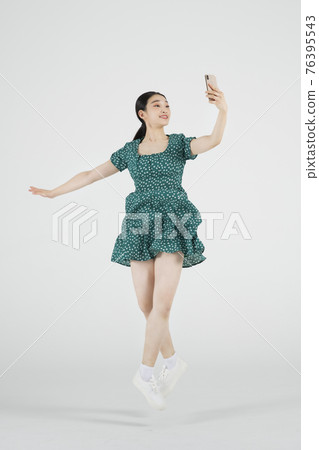 sale promotion concept, contemporary female dancer with smarphone on hand sale promotion concept, contemporary female dancer with smarphone on hand 76395543