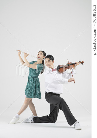 Asian couple contemporary dancers playing violin and flute Asian couple contemporary dancers playing violin and flute 76395612