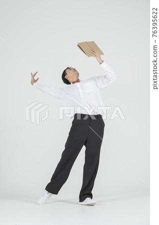 Asian male contemporary dancer holding book Asian male contemporary dancer holding book 76395622