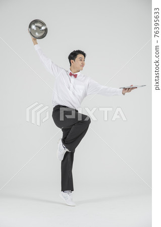 Asian male contemporary dancer holding plate serving cover Asian male contemporary dancer holding plate serving cover 76395633