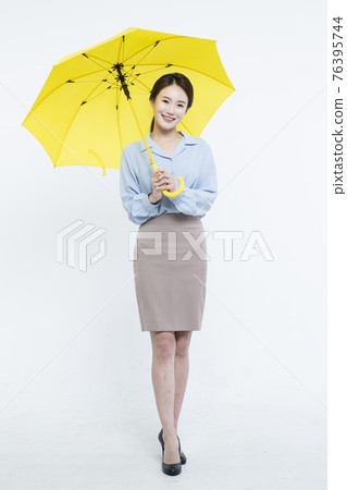 Asian business woman with yellow umbrella 76395744