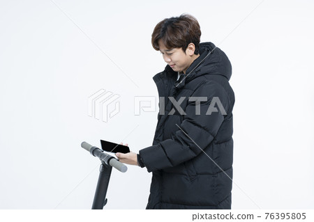 man in winter fashion riding electric scooter, white background 76395805