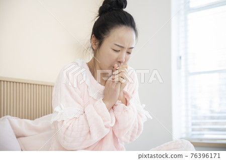 sick Asian woman in bed 76396171