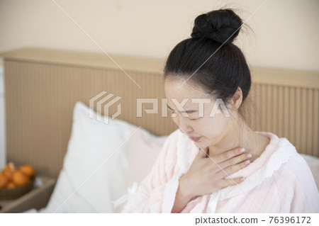 sick Asian woman in bed sick Asian woman in bed 76396172