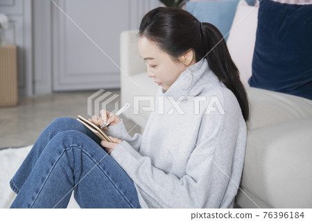 Asian single solo woman living alone concept writing diary Asian single solo woman living alone concept writing diary 76396184