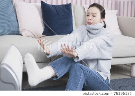 Asian single solo woman living alone concept using electric heater in winter Asian single solo woman living alone concept using electric heater in winter 76396185