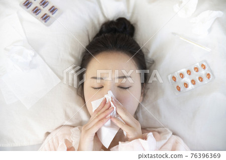 sick Asian woman in bed sick Asian woman in bed 76396369