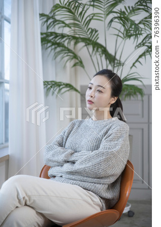 beautiful Asian woman sitting on chair 76396390