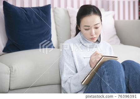 Asian single solo woman living alone concept writing diary Asian single solo woman living alone concept writing diary 76396391