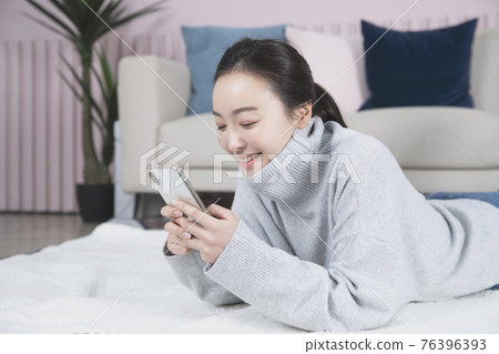 Asian single solo woman living alone concept using smartphone Asian single solo woman living alone concept using smartphone 76396393