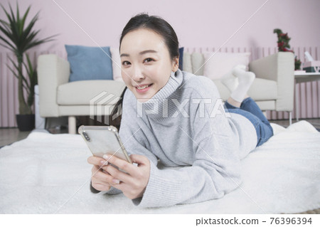 Asian single solo woman living alone concept using smartphone Asian single solo woman living alone concept using smartphone 76396394