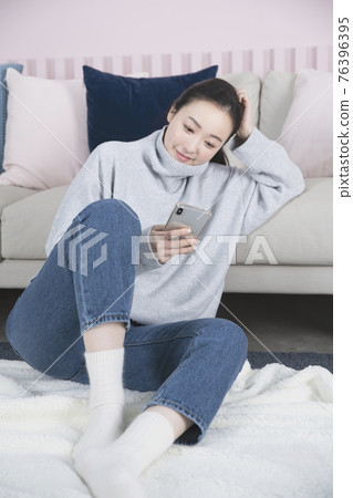 Asian single solo woman living alone concept using smartphone Asian single solo woman living alone concept using smartphone 76396395