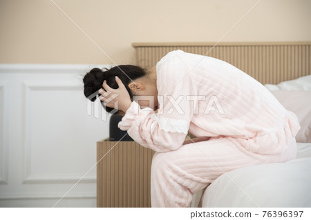 sick Asian woman in bed sick Asian woman in bed 76396397