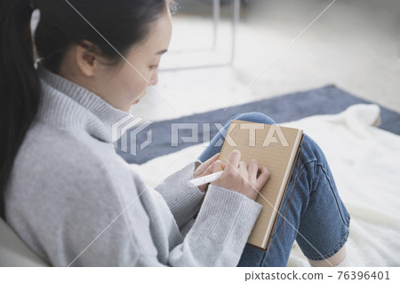 Asian single solo woman living alone concept writing diary Asian single solo woman living alone concept writing diary 76396401