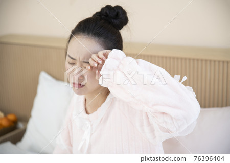 sick Asian woman in bed 76396404