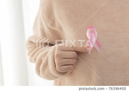 woman holding breast cancer ribbon woman holding breast cancer ribbon 76396408