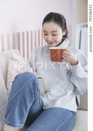 Asian single solo woman living alone concept drinking hot tea or coffeee Asian single solo woman living alone concept drinking hot tea or coffeee 76396431