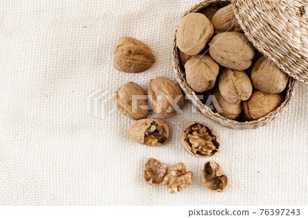 walnuts in woven basket 76397243