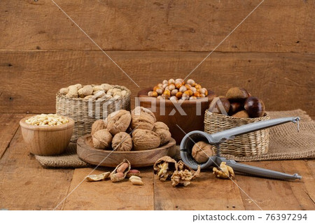 mix of pine nuts, walnuts, ginkgo nuts, chestnuts, peanuts and nutcracker 76397294