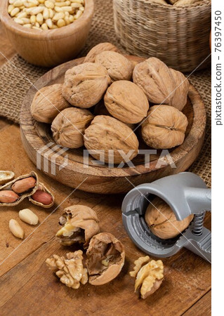 mix of pine nuts, walnuts, ginkgo nuts, chestnuts, peanuts and nutcracker 76397450