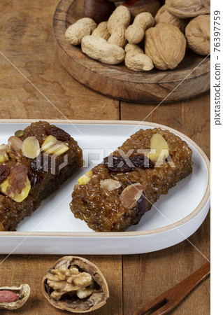 Yakbap, Korean dessert flavored glutinous rice mixed with honey, dates, chestnuts Yakbap, Korean dessert flavored glutinous rice mixed with honey, dates, chestnuts 76397759