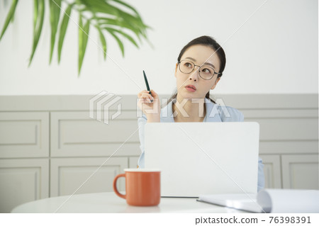 remote work, working at home concept of Asian woman in smart casual attire remote work, working at home concept of Asian woman in smart casual attire 76398391