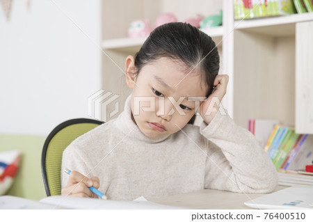 Asian girl studying on table using laptop device Asian girl studying on table using laptop device 76400510